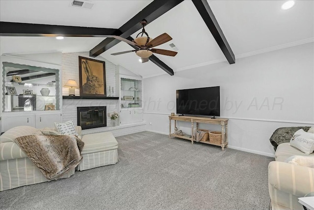 carpeted living room with ceiling fan, lofted ceiling with beams, and a brick fireplace