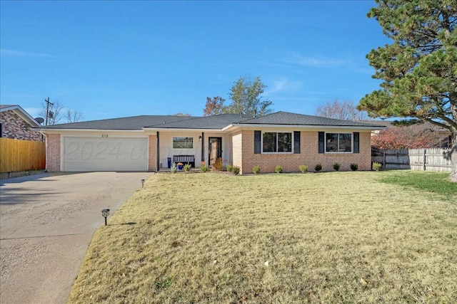 ranch-style home featuring a front lawn and a garage