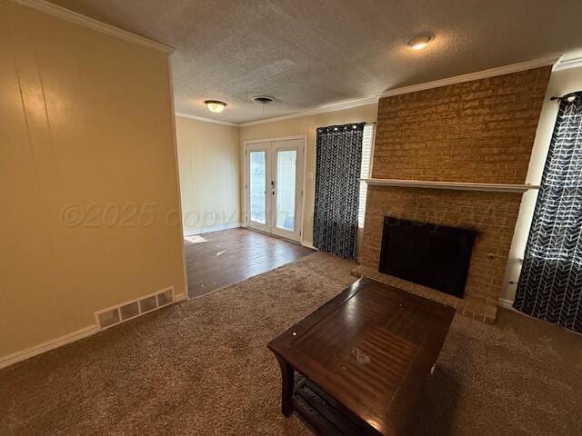 unfurnished living room featuring crown molding, carpet flooring, visible vents, and a textured ceiling