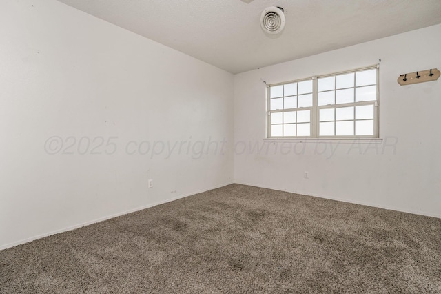 spare room with carpet and visible vents