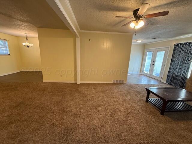 unfurnished room with visible vents, carpet, crown molding, and french doors