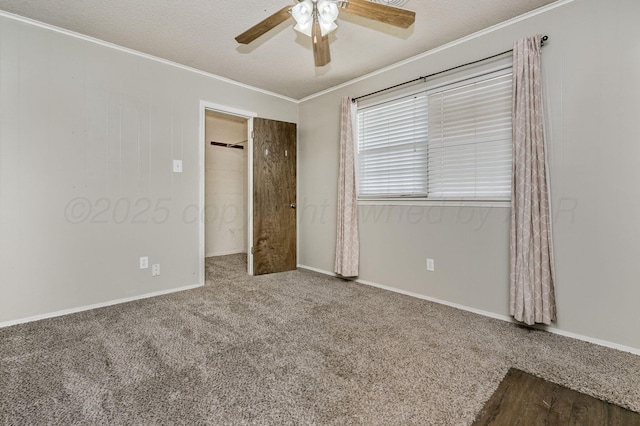 unfurnished bedroom with crown molding, carpet flooring, a ceiling fan, a textured ceiling, and baseboards