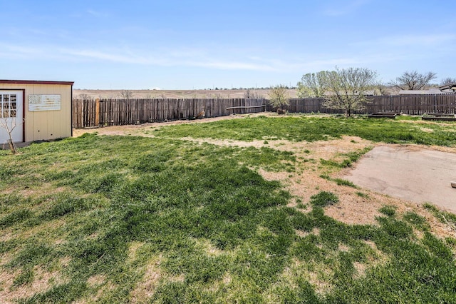 view of yard featuring a fenced backyard and an outbuilding