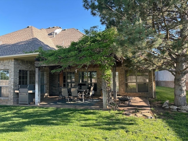 7 Pebble Beach Ct, Amarillo, TX 79124 - rear view of property with a patio area, a shingled roof, a lawn, brick siding, and a fire pit