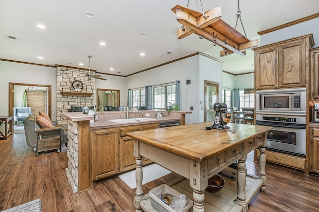 7 Pebble Beach Ct, Amarillo, TX 79124 - kitchen with appliances with stainless steel finishes, a sink, light countertops, healthy amount of natural light, and ornamental molding