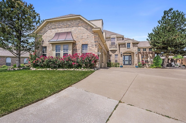 7 Pebble Beach Ct, Amarillo, TX 79124 - view of front of home with a front lawn, brick siding, stone siding, and driveway
