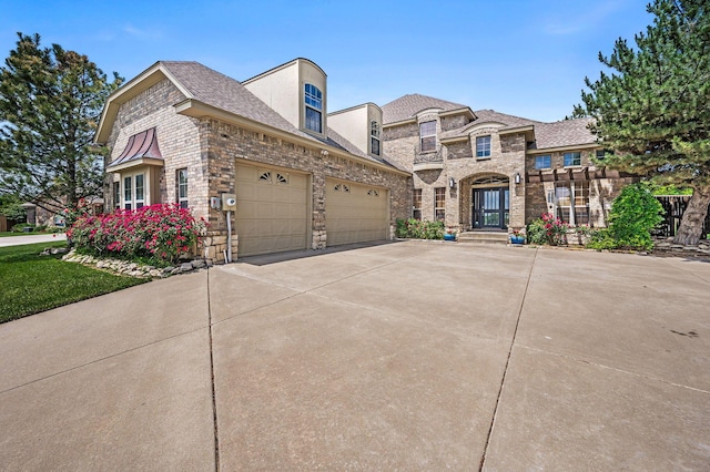 7 Pebble Beach Ct, Amarillo, TX 79124 - french country style house with concrete driveway, an attached garage, brick siding, and roof with shingles