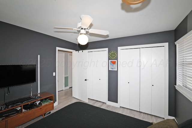 6006 Elmhurst Rd, Amarillo, TX 79106 - bedroom featuring two closets, wood finished floors, ceiling fan, and baseboards