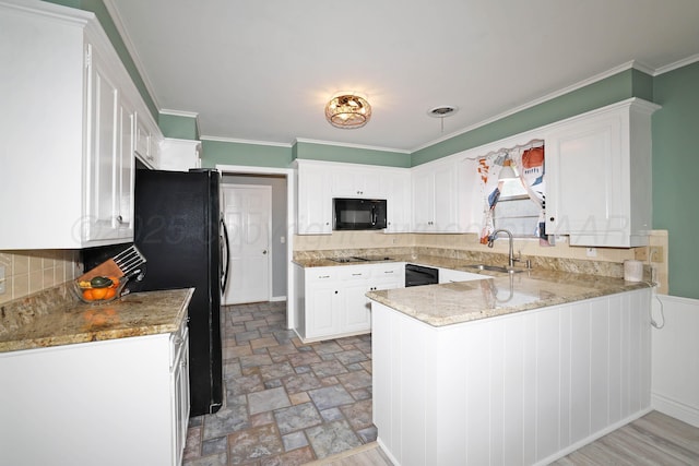 6006 Elmhurst Rd, Amarillo, TX 79106 - kitchen with black appliances, a sink, a peninsula, white cabinetry, and ornamental molding