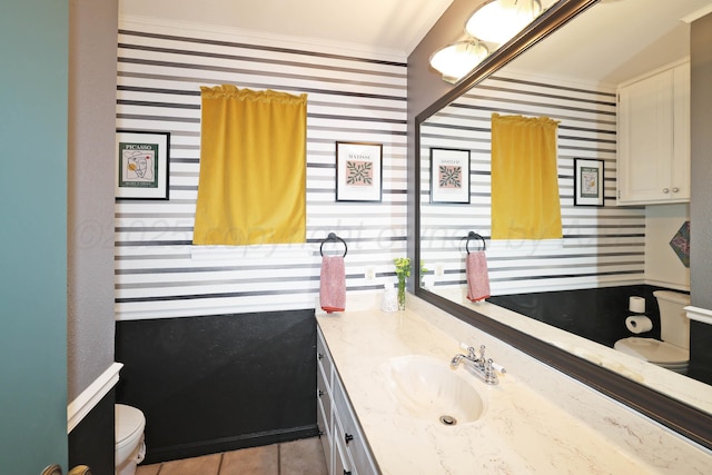 6006 Elmhurst Rd, Amarillo, TX 79106 - bathroom with toilet, vanity, crown molding, and tile patterned flooring