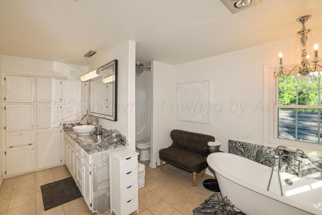 620 N Main St, Stratford, TX 79084 - full bath with tile patterned flooring, a freestanding bath, vanity, and a chandelier