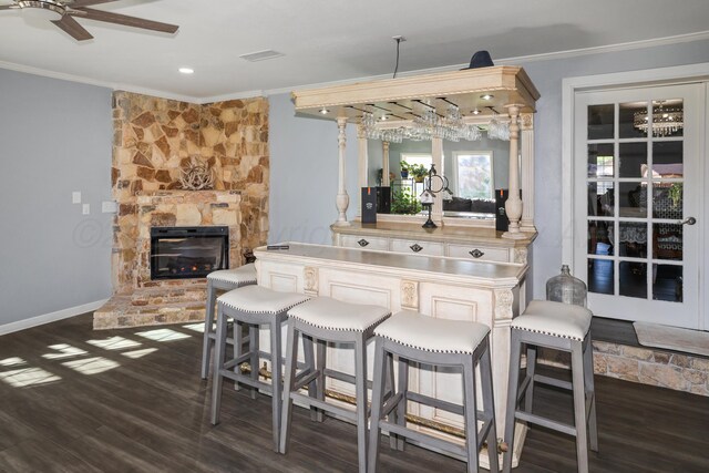 620 N Main St, Stratford, TX 79084 - kitchen with crown molding, a ceiling fan, wood finished floors, a fireplace, and baseboards