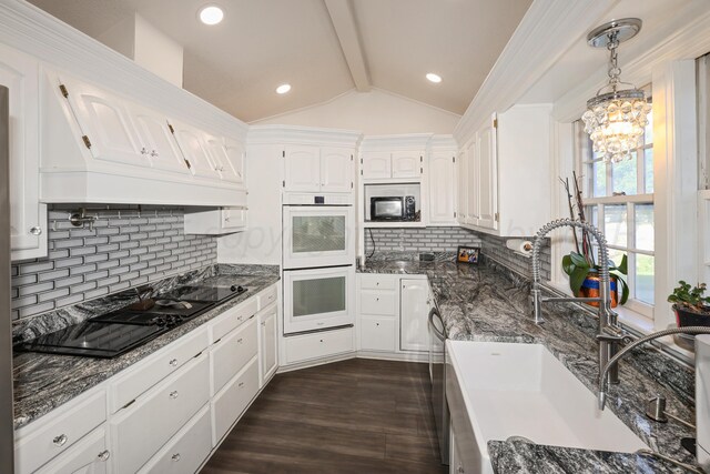 620 N Main St, Stratford, TX 79084 - kitchen with double oven, a sink, white cabinetry, backsplash, and dark wood finished floors