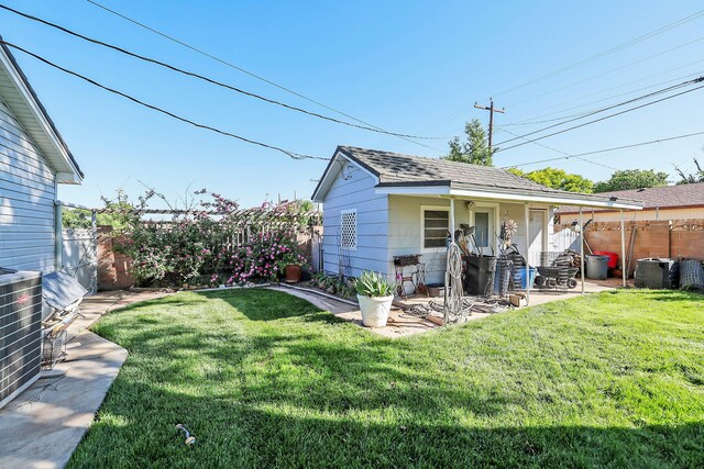 620 N Main St, Stratford, TX 79084 - rear view of property featuring a patio and a shingled roof