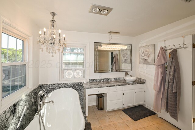 620 N Main St, Stratford, TX 79084 - full bathroom with a freestanding bath, vanity, tile patterned floors, and healthy amount of natural light