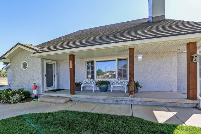 620 N Main St, Stratford, TX 79084 - rear view of house with covered porch, stucco siding, and a tiled roof