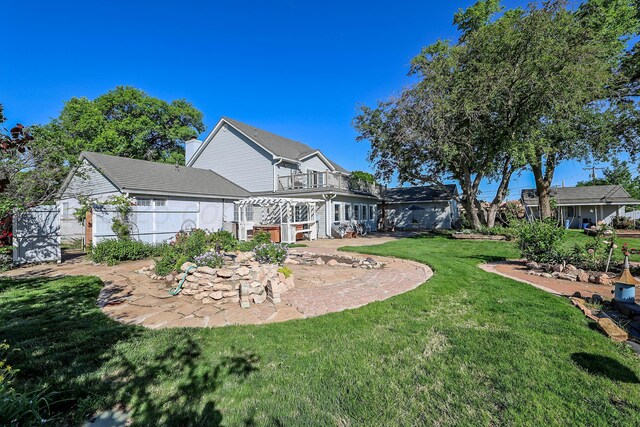 620 N Main St, Stratford, TX 79084 - rear view of house with a patio and a balcony