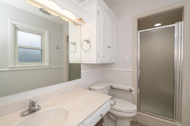 bathroom featuring vanity, toilet, and an enclosed shower