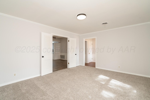 carpeted empty room with crown molding