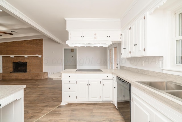 kitchen with wood-type flooring, black appliances, a brick fireplace, ornamental molding, and white cabinets