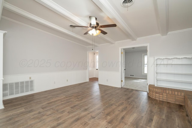 empty room featuring beamed ceiling, ceiling fan, dark hardwood / wood-style floors, and crown molding