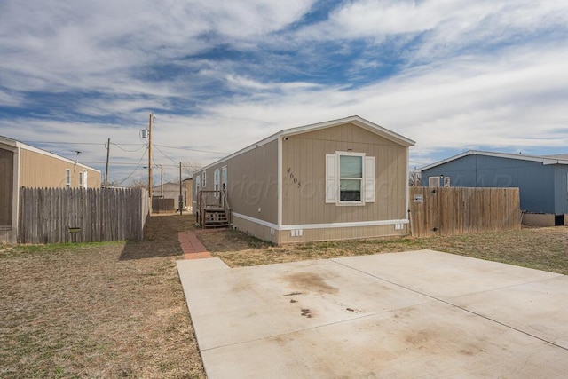 view of property exterior with a patio area