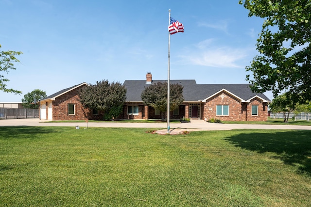 ranch-style home featuring a garage and a front yard