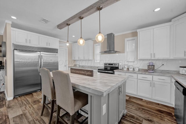 2004 Pheasant Ln, Amarillo, TX 79118 - kitchen with wall chimney exhaust hood, stainless steel appliances, decorative backsplash, a center island, and dark wood finished floors