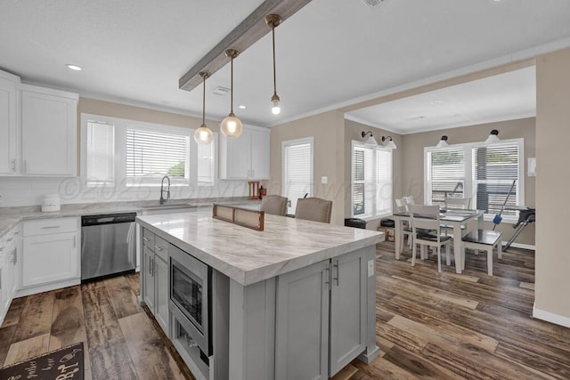 2004 Pheasant Ln, Amarillo, TX 79118 - kitchen with appliances with stainless steel finishes, light countertops, crown molding, tasteful backsplash, and dark wood-style flooring
