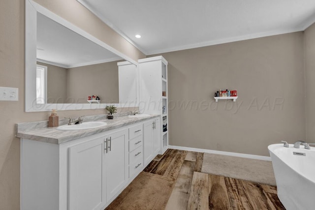 2004 Pheasant Ln, Amarillo, TX 79118 - bathroom with wood finished floors, double vanity, a freestanding tub, ornamental molding, and recessed lighting