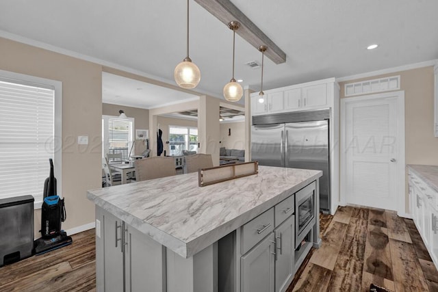 2004 Pheasant Ln, Amarillo, TX 79118 - kitchen featuring built in appliances, dark wood-type flooring, a kitchen island, pendant lighting, and crown molding