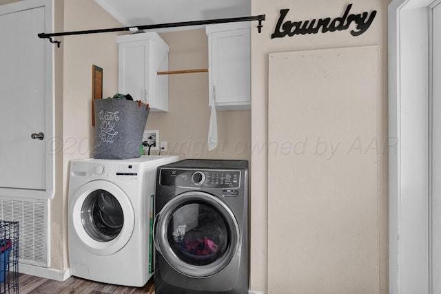 2004 Pheasant Ln, Amarillo, TX 79118 - laundry area featuring cabinet space, washing machine and clothes dryer, and wood finished floors