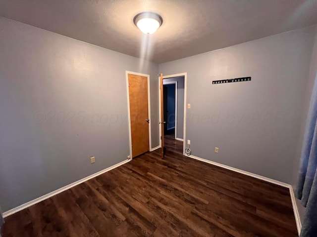 224 Beach St, Hereford, TX 79045 - empty room with dark wood-type flooring and baseboards