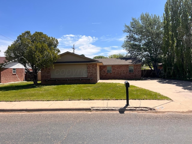 224 Beach St, Hereford, TX 79045 - view of front facade with brick siding and a front yard