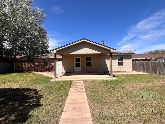 224 Beach St, Hereford, TX 79045 - rear view of house with a lawn, fence, and a patio area