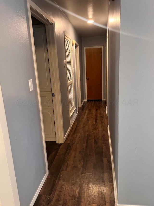 224 Beach St, Hereford, TX 79045 - corridor featuring baseboards and dark wood-style floors