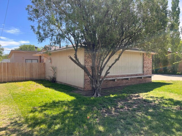 224 Beach St, Hereford, TX 79045 - view of side of home featuring fence and a lawn
