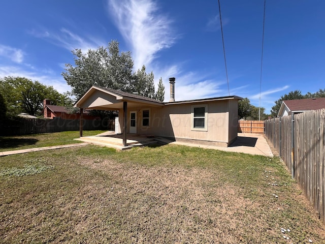 224 Beach St, Hereford, TX 79045 - rear view of house with a patio, a fenced backyard, and a yard