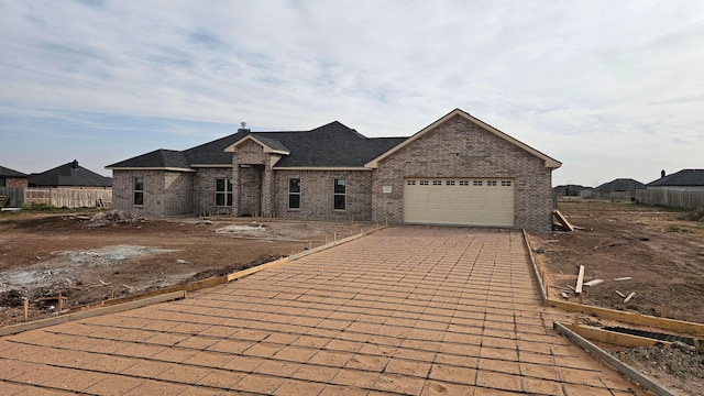 french country style house with a garage