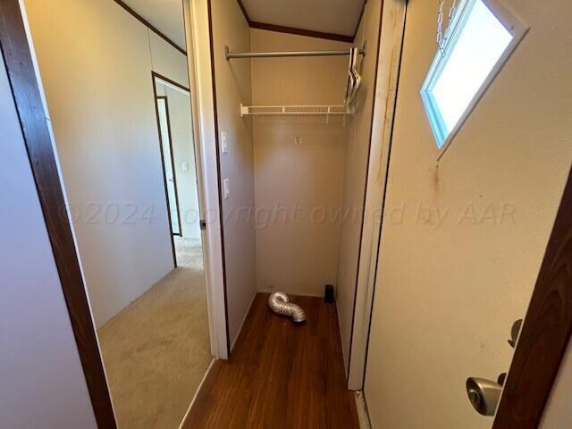 interior space with hardwood / wood-style floors and lofted ceiling