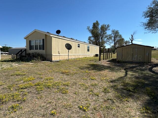 view of property exterior featuring a shed