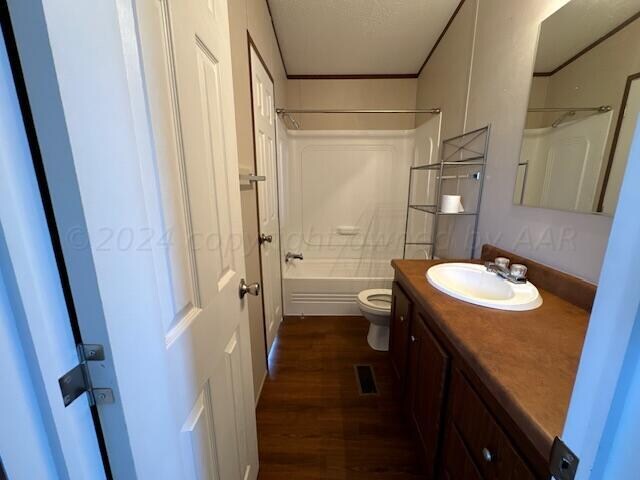 full bathroom with wood-type flooring, vanity, toilet, and shower / bathtub combination