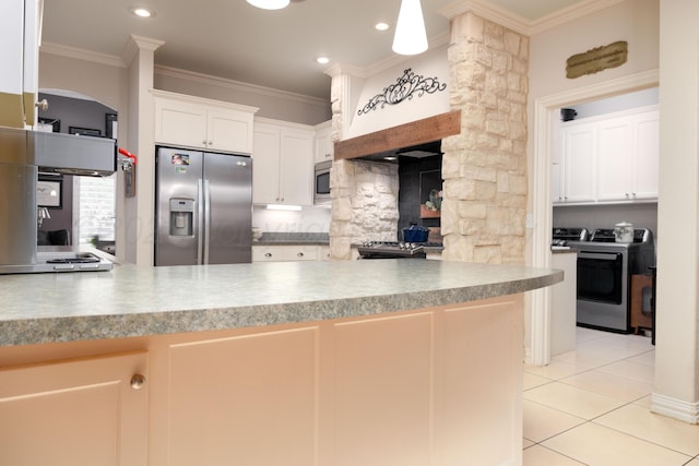 5007 Wesley Rd, Amarillo, TX 79119 - kitchen with appliances with stainless steel finishes, ornamental molding, light tile patterned flooring, washer and clothes dryer, and tasteful backsplash