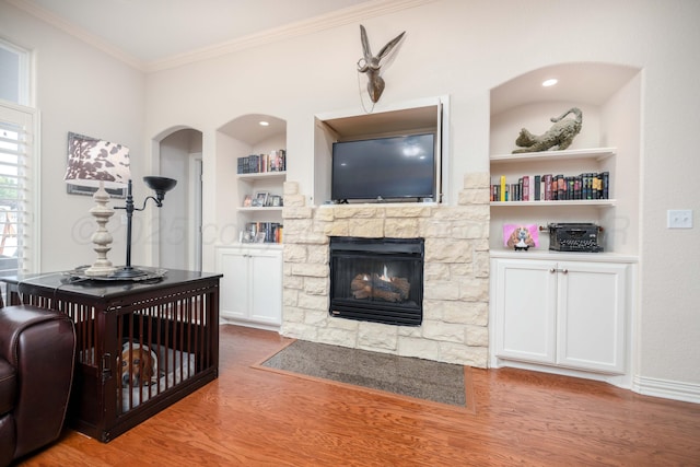 5007 Wesley Rd, Amarillo, TX 79119 - living area featuring crown molding, wood finished floors, built in features, and a fireplace