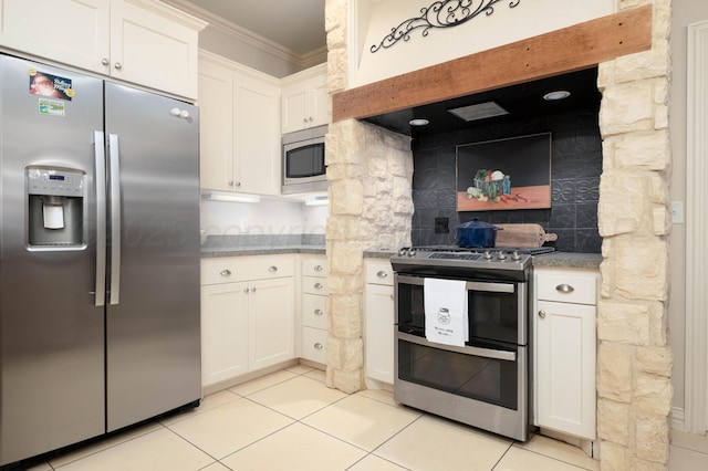 5007 Wesley Rd, Amarillo, TX 79119 - kitchen featuring appliances with stainless steel finishes, tasteful backsplash, crown molding, white cabinets, and light tile patterned floors