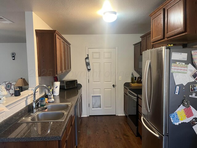4406 S Roberts St, Amarillo, TX 79118 - kitchen with freestanding refrigerator, a sink, range with electric stovetop, dark wood-style floors, and a peninsula