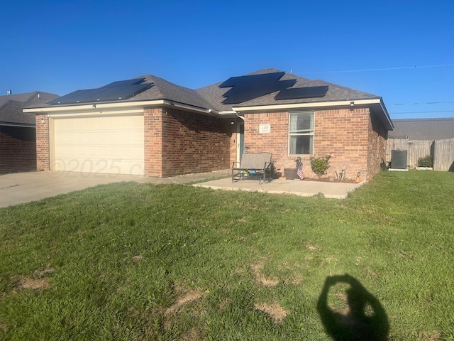 4406 S Roberts St, Amarillo, TX 79118 - single story home with cooling unit, brick siding, a garage, and roof mounted solar panels