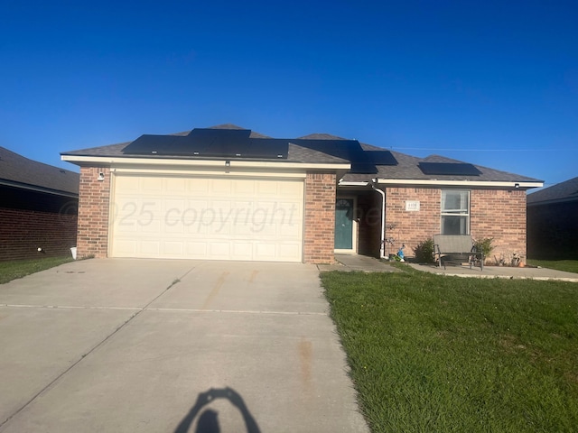 4406 S Roberts St, Amarillo, TX 79118 - ranch-style house featuring driveway, brick siding, a front yard, roof mounted solar panels, and an attached garage