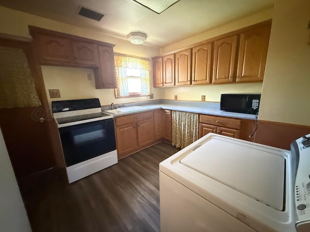 1030 Thrams St, Borger, TX 79007 - kitchen featuring electric stove, black microwave, a sink, dark wood-type flooring, and washer / dryer