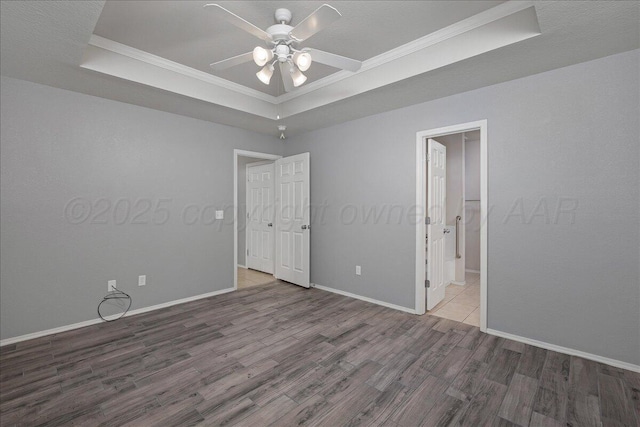 3610 S Mirror St, Amarillo, TX 79118 - unfurnished bedroom with a tray ceiling, wood finished floors, crown molding, and ceiling fan